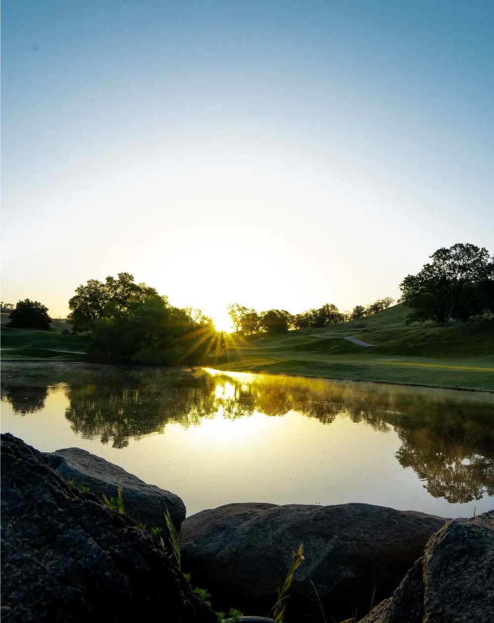 Golf course behind a body of water